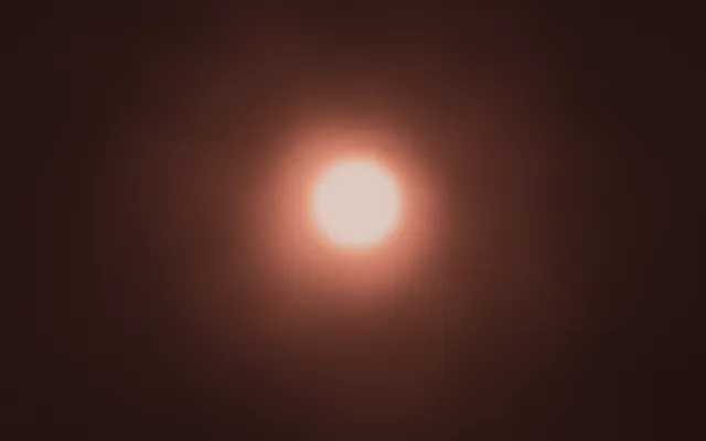 A single glowing orb of cream light with a soft peach halo, centered on a dark brown background.